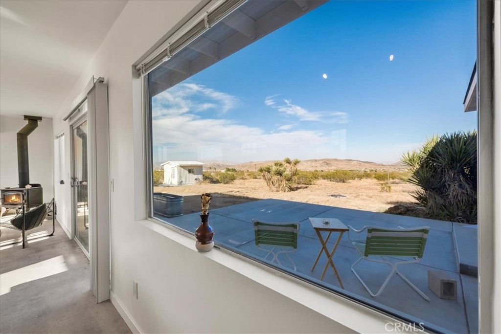 2625 Geronimo Trail Yucca Valley, CA 92285 - Photo 13 of 57 a view of a terrace with a flat screen tv