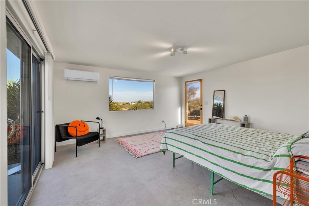 2625 Geronimo Trail Yucca Valley, CA 92285 - Photo 14 of 57 a bedroom with a bed and wooden floor