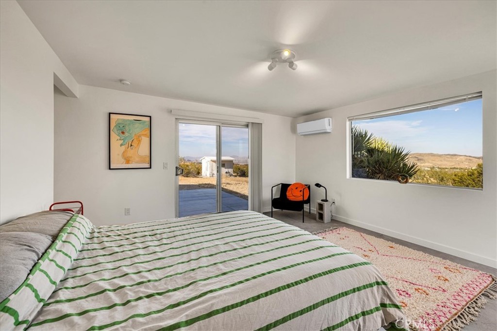 2625 Geronimo Trail Yucca Valley, CA 92285 - Photo 15 of 57 a bedroom with a bed and a dresser in it