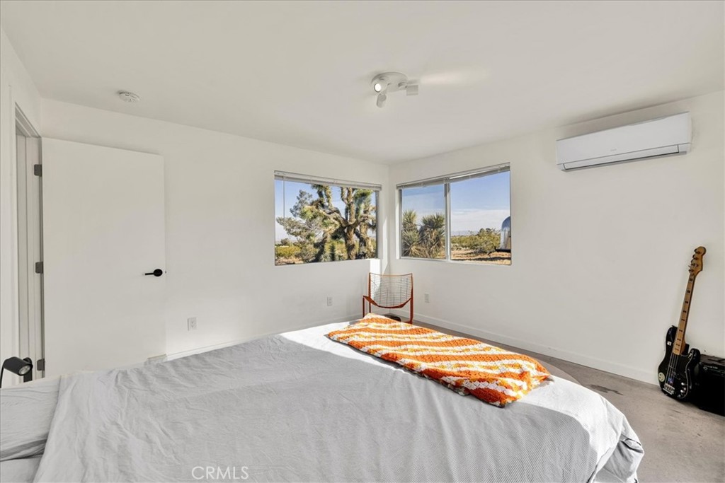 2625 Geronimo Trail Yucca Valley, CA 92285 - Photo 20 of 57 a bedroom with a bed and a window