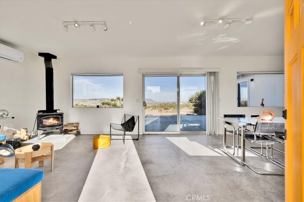 2625 Geronimo Trail Yucca Valley, CA 92285 - Photo 4 of 57 a living room with furniture a large window and kitchen view