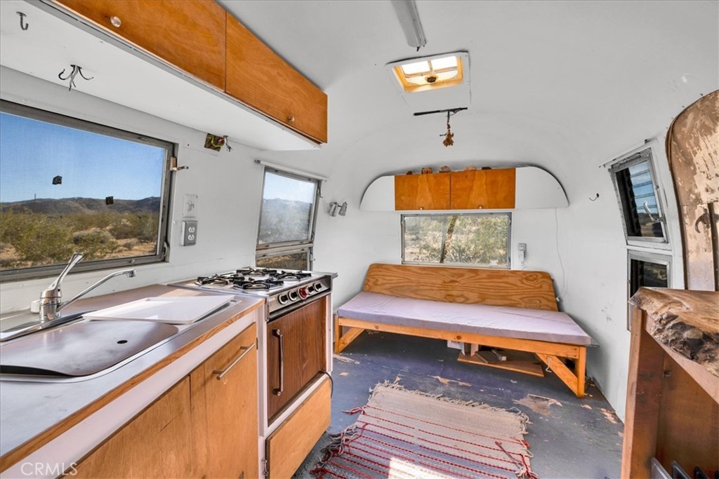 2625 Geronimo Trail Yucca Valley, CA 92285 - Photo 45 of 57 a bedroom with furniture and a flat screen tv