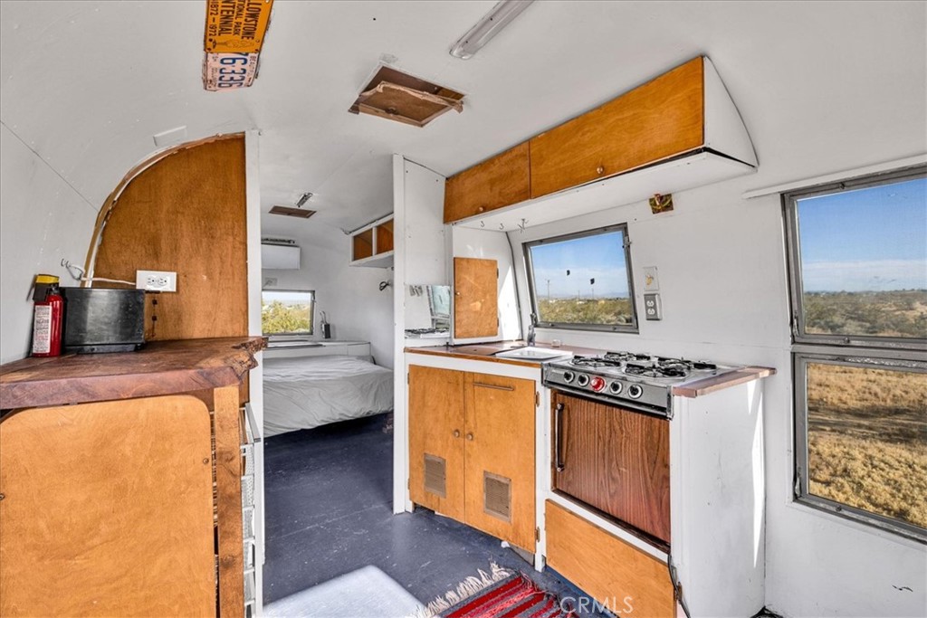 2625 Geronimo Trail Yucca Valley, CA 92285 - Photo 46 of 57 a kitchen with stainless steel appliances granite countertop a stove a sink and a refrigerator