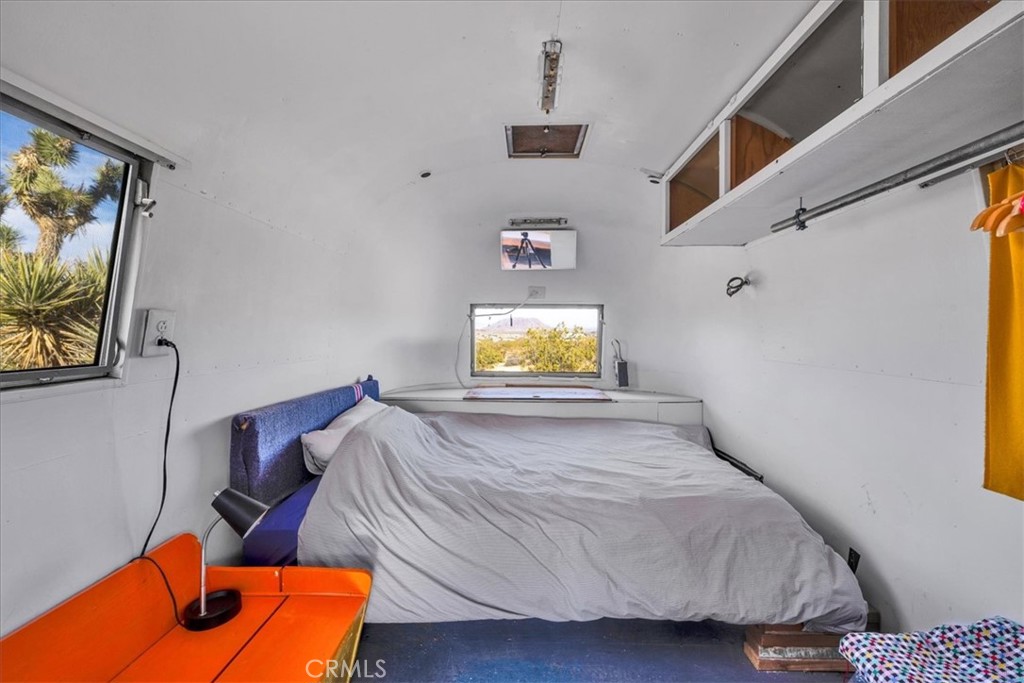 2625 Geronimo Trail Yucca Valley, CA 92285 - Photo 47 of 57 a bedroom with a bed and a flat screen tv