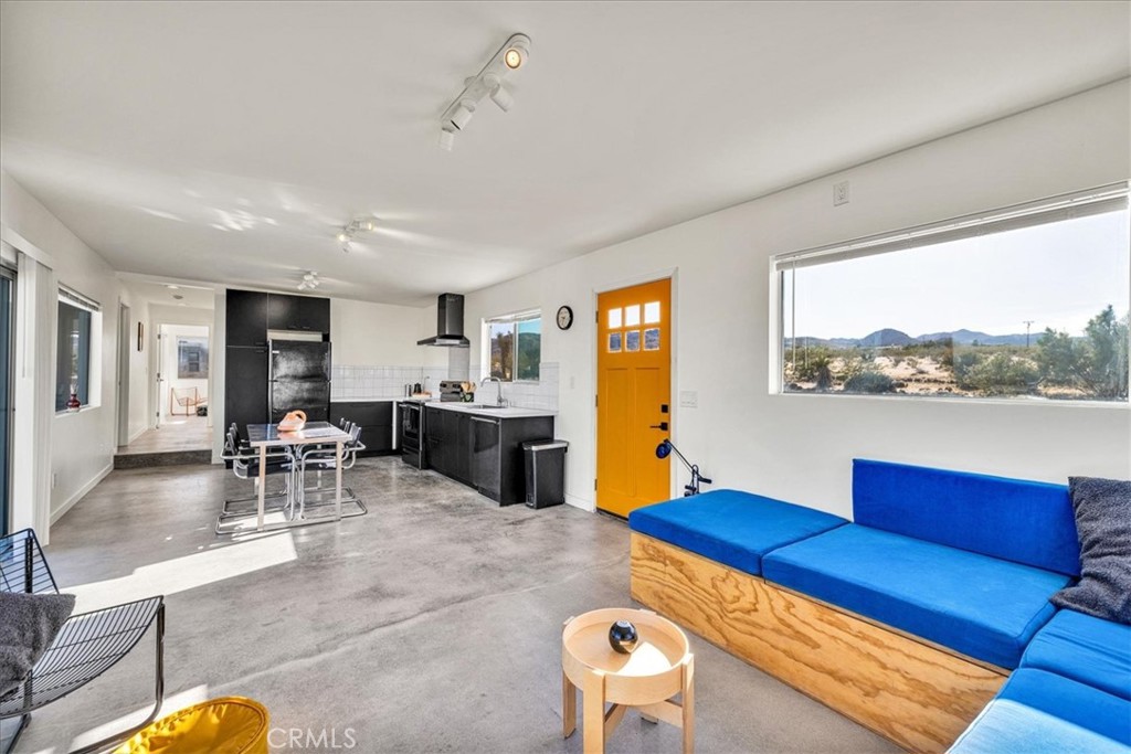2625 Geronimo Trail Yucca Valley, CA 92285 - Photo 5 of 57 a living room with furniture and a large window