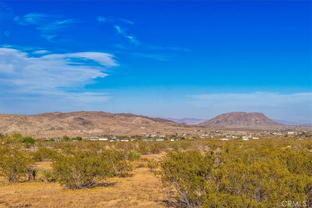 2625 Geronimo Trail Yucca Valley, CA 92285 - Photo 51 of 57 a view of a mountain range in a cloudy sky