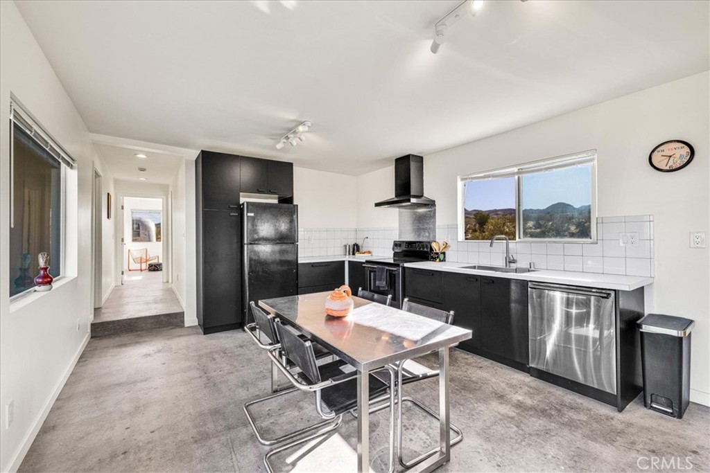 2625 Geronimo Trail Yucca Valley, CA 92285 - Photo 8 of 57 a kitchen with stainless steel appliances kitchen island granite countertop a sink and cabinets