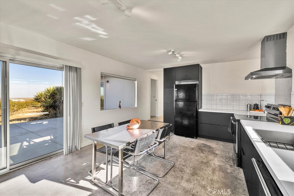 2625 Geronimo Trail Yucca Valley, CA 92285 - Photo 9 of 57 a kitchen with a table and chairs in it