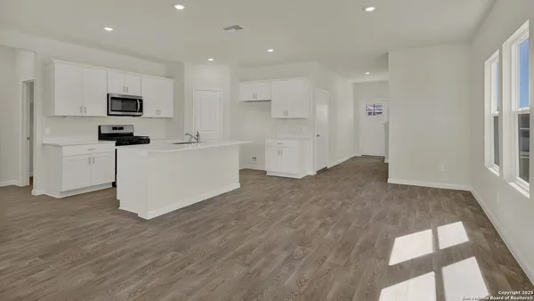 a view of a room with wooden floor and window