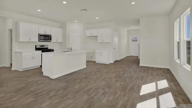 a view of a room with wooden floor and window