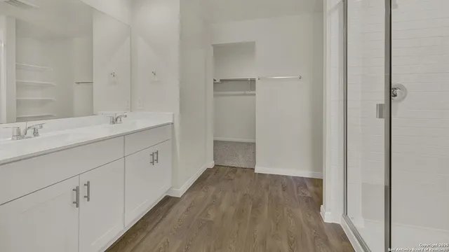 a bathroom with a double vanity sink and a mirror
