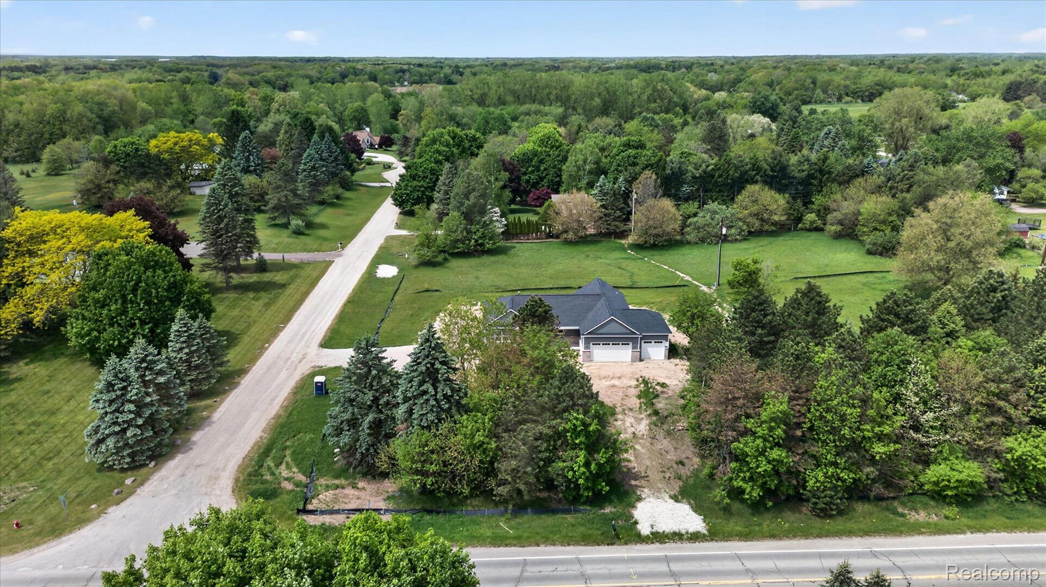 3297 Oak Grove Road Howell, MI 48855 - Photo 28 of 40 Aerial view highlighting the spacious lot and surrounding mature trees.