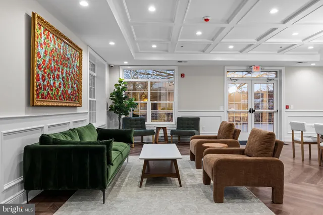 a living room with fireplace furniture and a large window