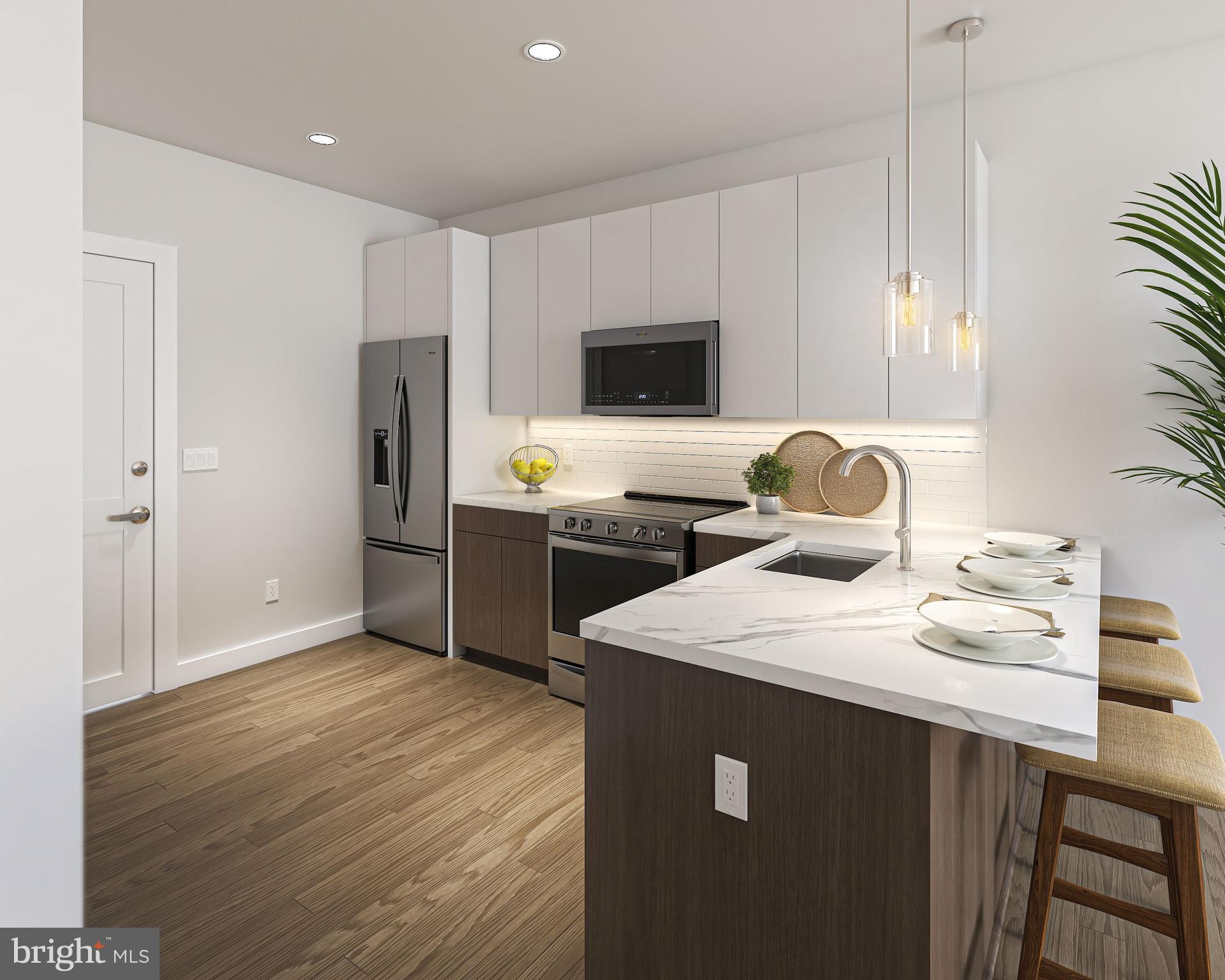 2500 Kelly Road Warrington, PA 18976 - Photo 2 of 9 a kitchen with stainless steel appliances a sink a stove a refrigerator cabinets and a dining table