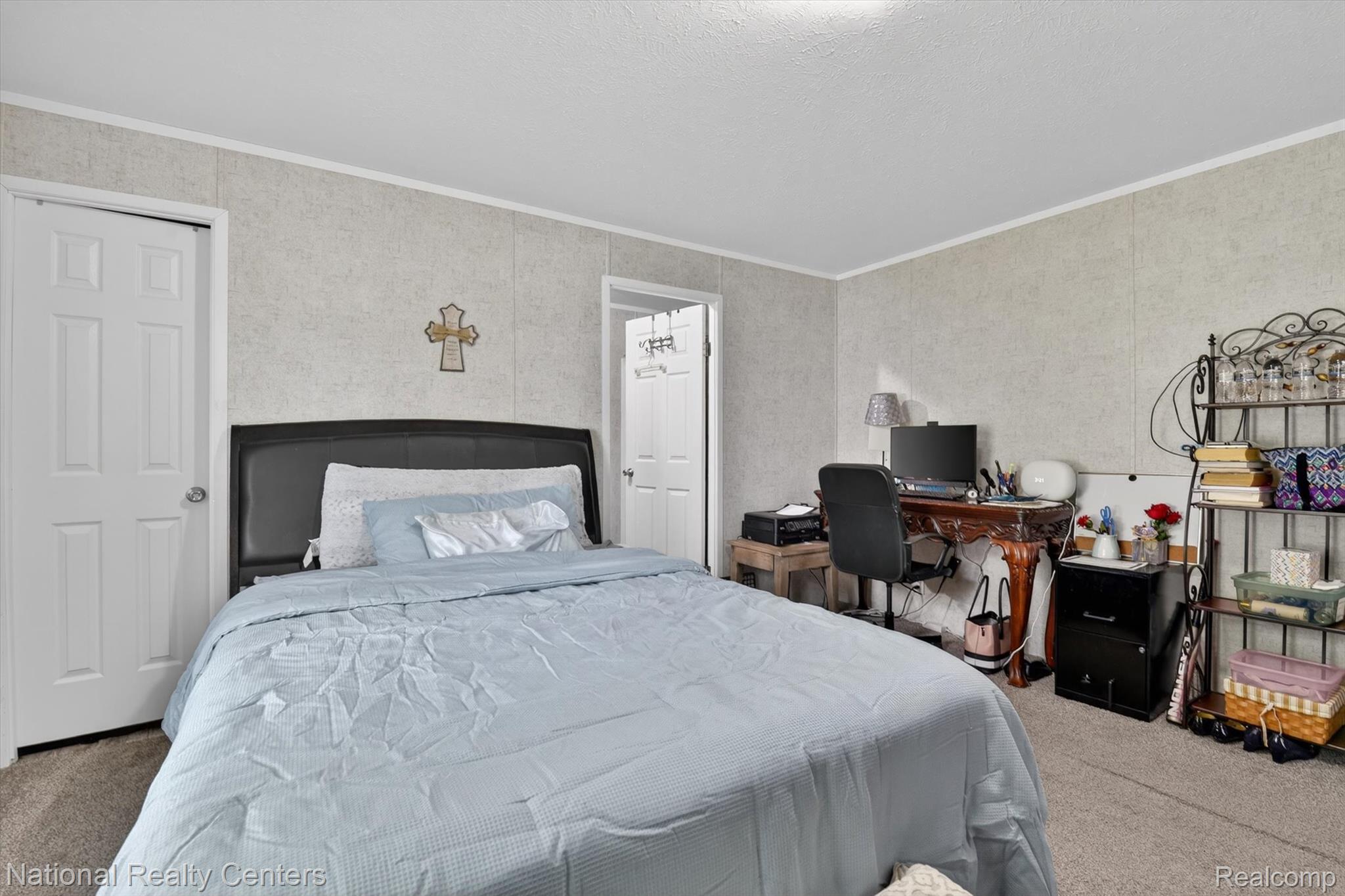 2735 South Wagner Road, Unit 103 Ann Arbor, MI 48103 - Photo 8 of 20 Bedroom featuring light colored carpet, ornamental molding, and a desk