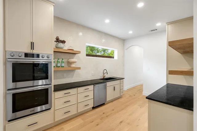a kitchen with stainless steel appliances a refrigerator and a stove