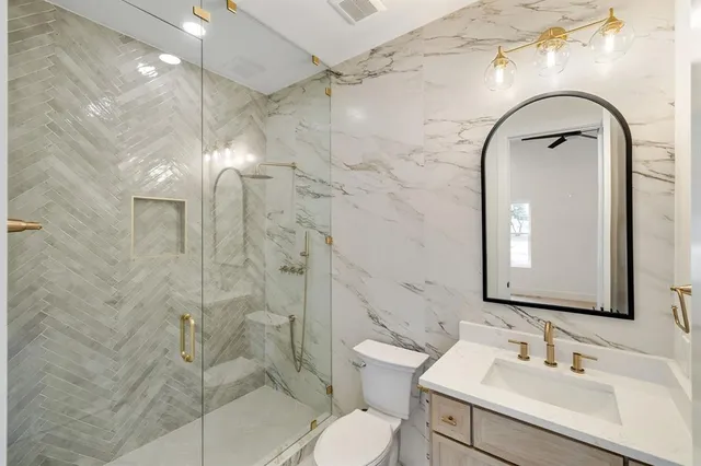 a bathroom with a sink toilet and shower