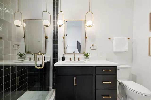 a bathroom with a sink vanity toilet and shower