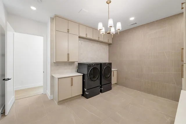 a view of a kitchen with a sink and a refrigerator