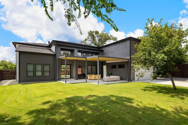 a view of a swimming pool with table and chairs under an umbrella