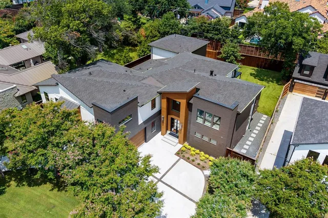 an aerial view of a house with garden space and street view
