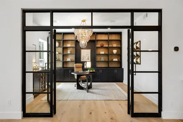 a living room with a wooden floor and furniture