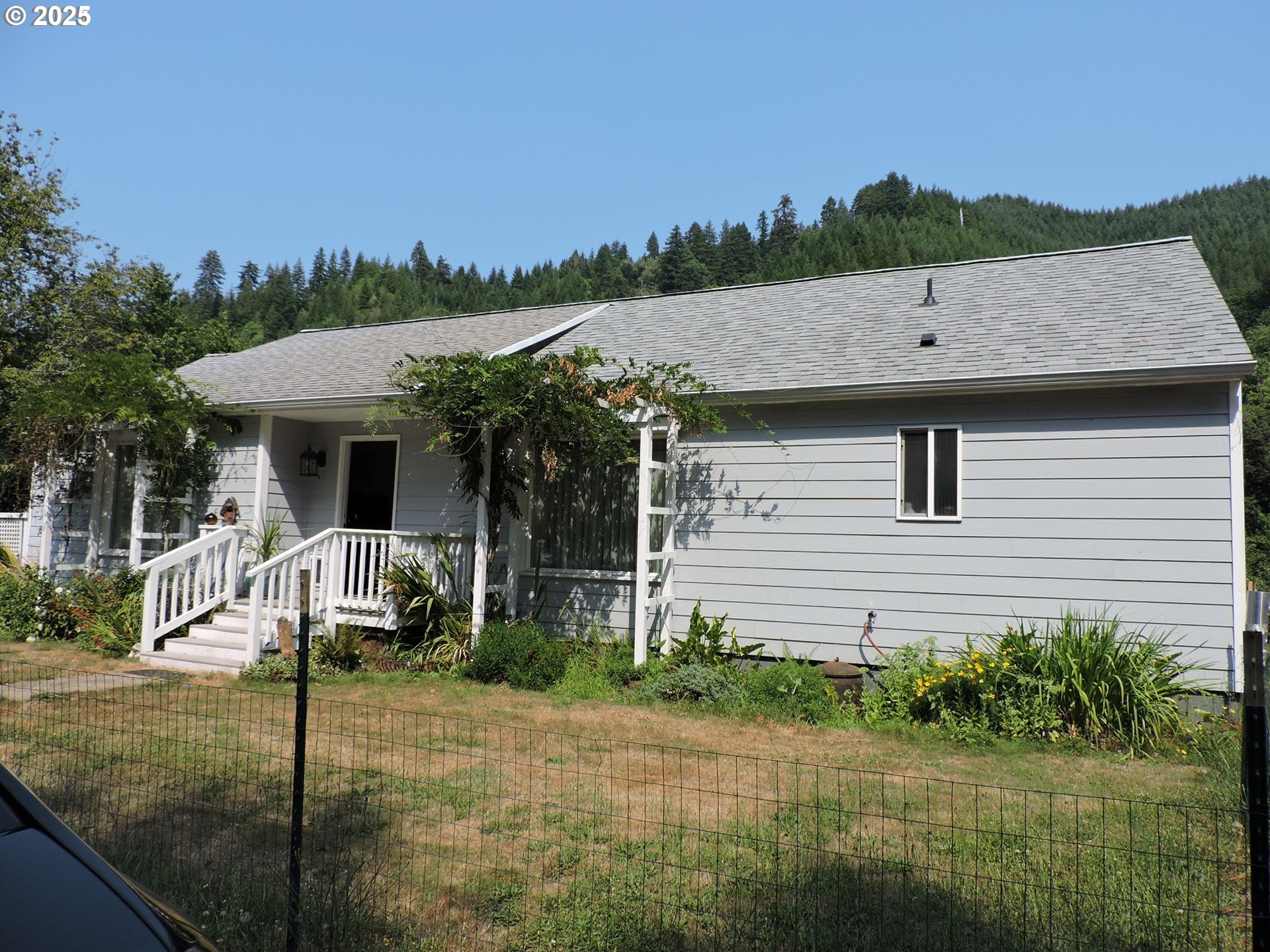 10742 Highway 126 Mapleton, OR 97453 - Photo 2 of 30 a view of a house with a backyard and a tree
