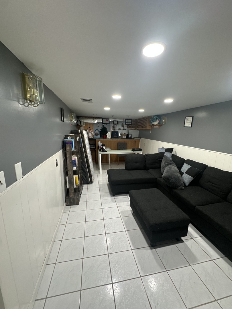 a living room with couches and kitchen view