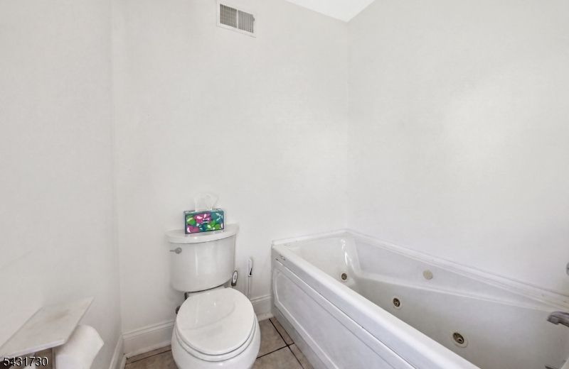 105 Main Street Lebanon, NJ 08833 - Photo 16 of 25 a white toilet sitting next to a bath tub