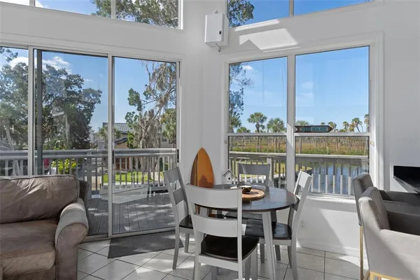 a view of a dining room with furniture large windows and wooden floor