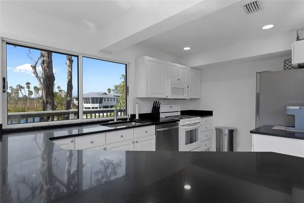 a kitchen with a sink stove and cabinets