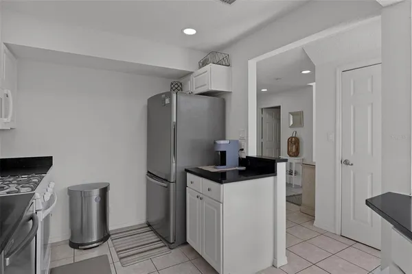 a kitchen with stainless steel appliances granite countertop a refrigerator and a stove
