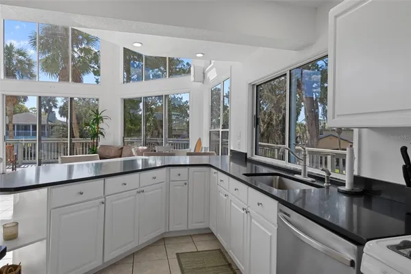 a kitchen with a sink and large window