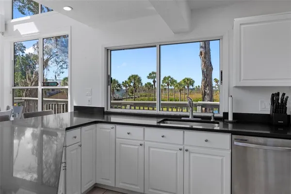 a kitchen with a sink and large window