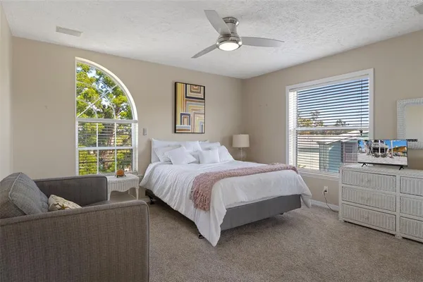 a living room with furniture a large window and a chandelier