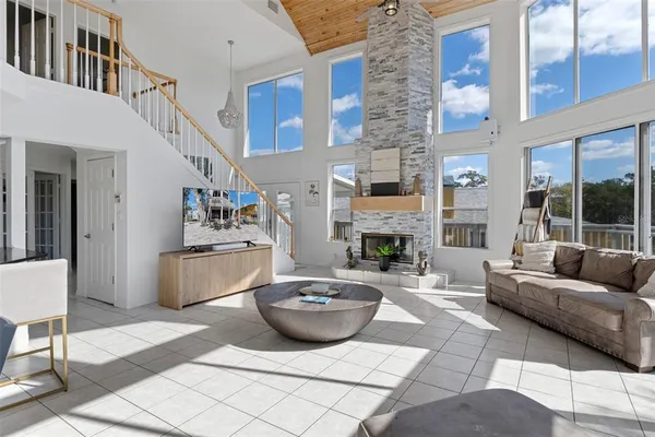 a living room with furniture a fireplace and a large window