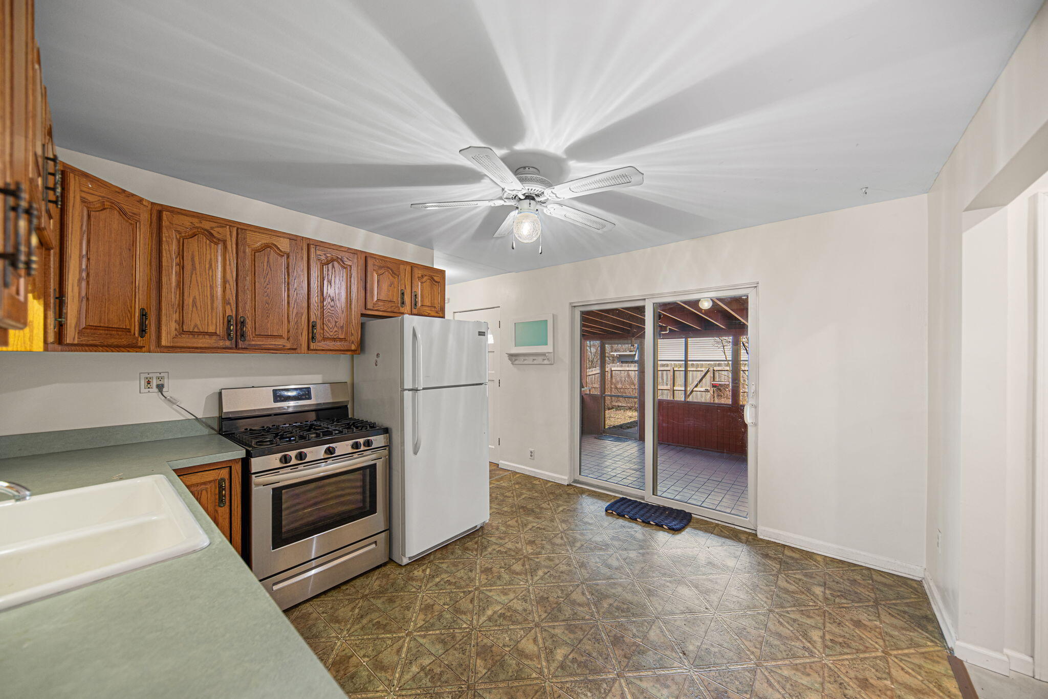 8632 Oak Avenue Gary, IN 46403 - Photo 10 of 34 a kitchen with stainless steel appliances a stove a refrigerator and cabinets