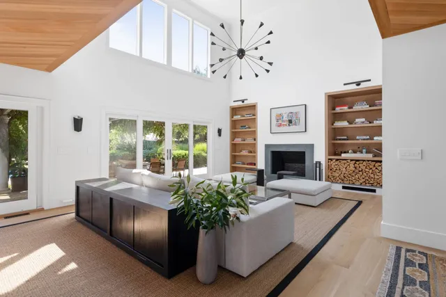 a living room with furniture or chandelier and a fireplace
