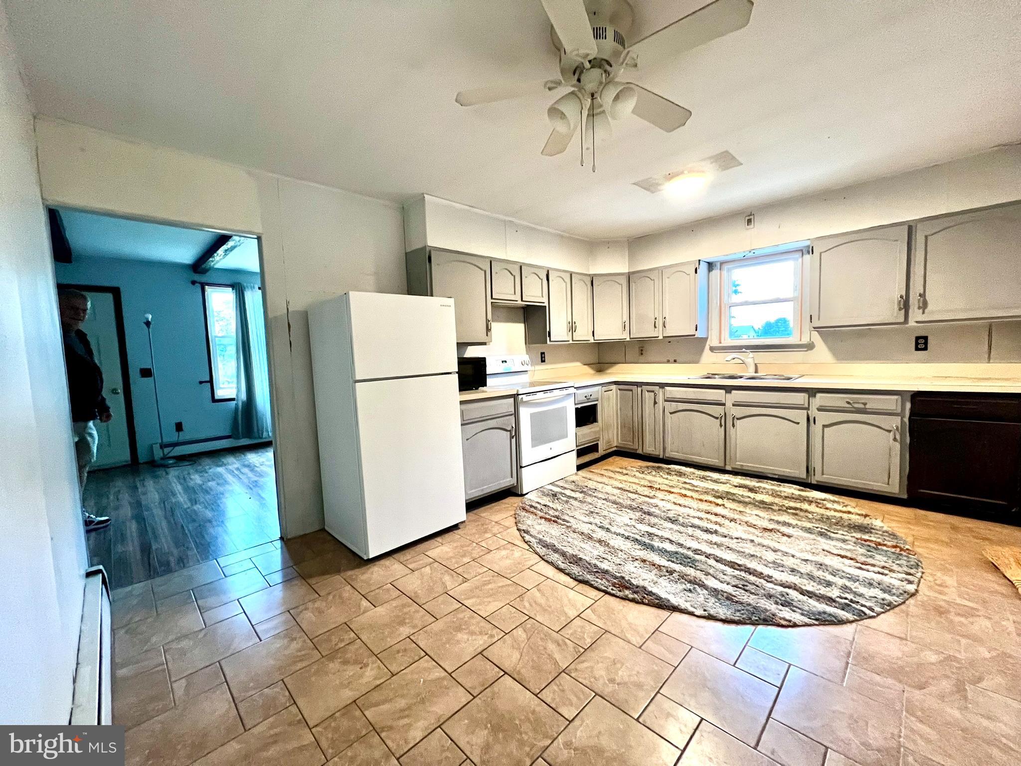 8690 Highway 25 Spring Glen, PA 17978 - Photo 16 of 31 a large white kitchen with cabinets