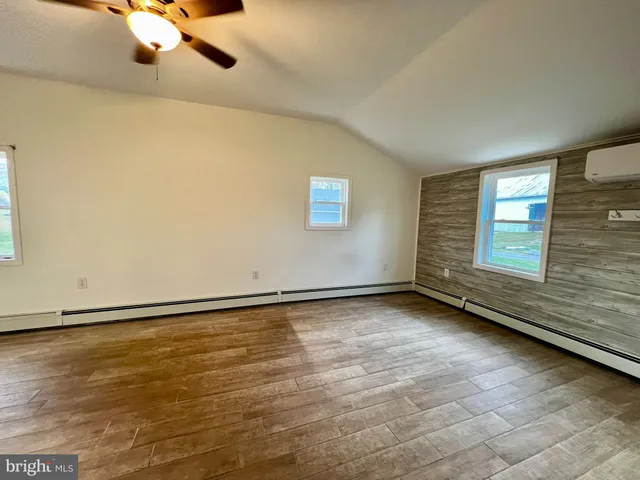 a spacious bathroom with a double vanity sink a mirror and a shower
