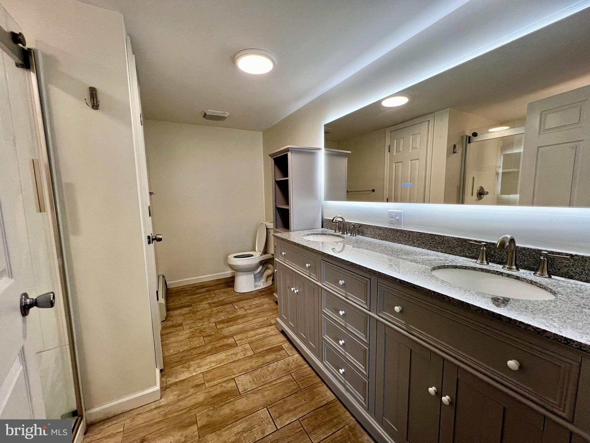 8690 Highway 25 Spring Glen, PA 17978 - Photo 22 of 31 a spacious bathroom with a double vanity sink a mirror and a shower