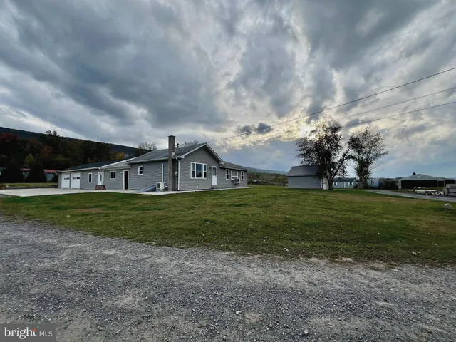 a view of a house next to a big yard