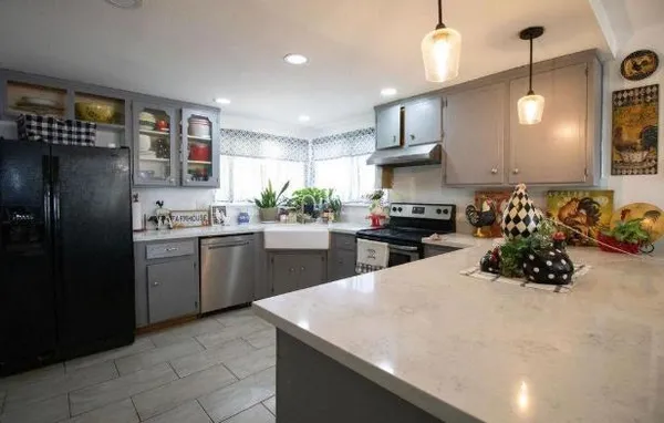 a kitchen with a sink stainless steel appliances and cabinets
