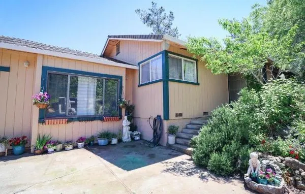 a front view of a house with garden
