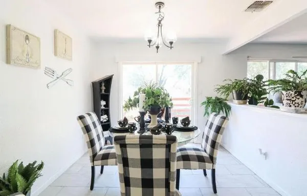 a view of a dining room with furniture and window