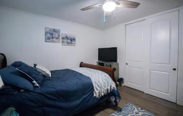 a bedroom with a bed and a flat screen tv