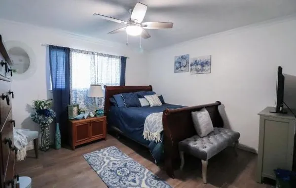 a bedroom with furniture and a window