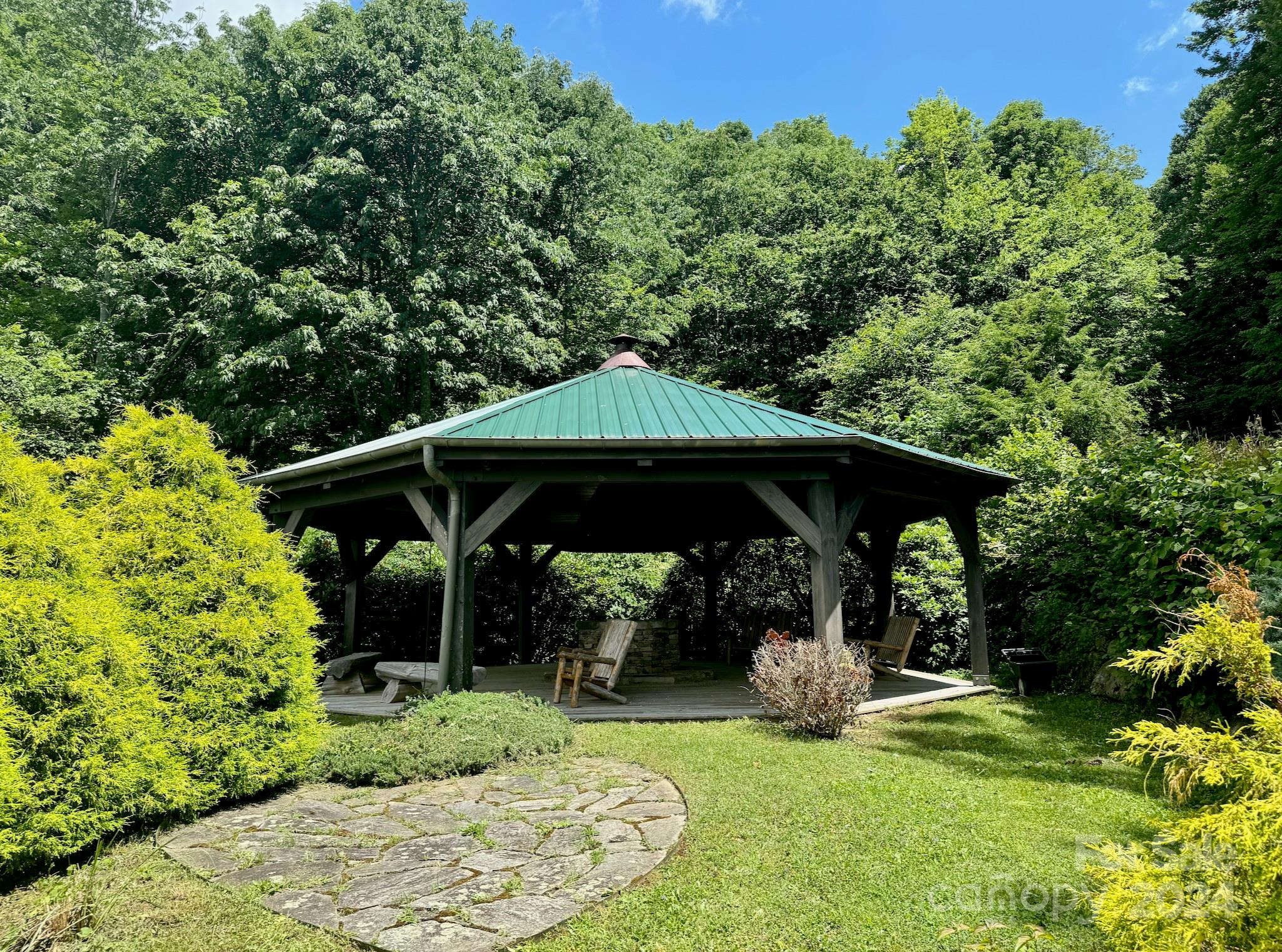 35 Flying Hawk Way Clyde, NC 28721 - Photo 19 of 22 a view of a deck with table and chairs under an umbrella