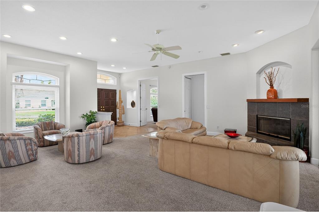 2968 Plantation Road Winter Haven, FL 33884 - Photo 11 of 81 a living room with furniture a fireplace and a flat screen tv