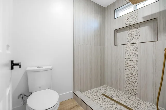 a bathroom with a toilet and a shower